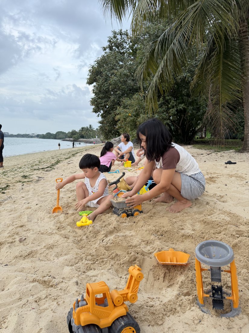 Helper playing with children at the beach